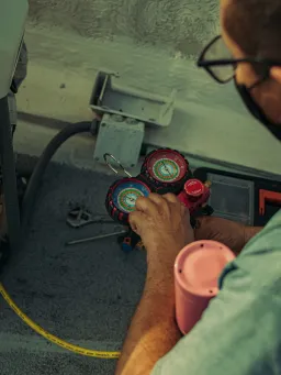 Air conditioning being maintained by a worker